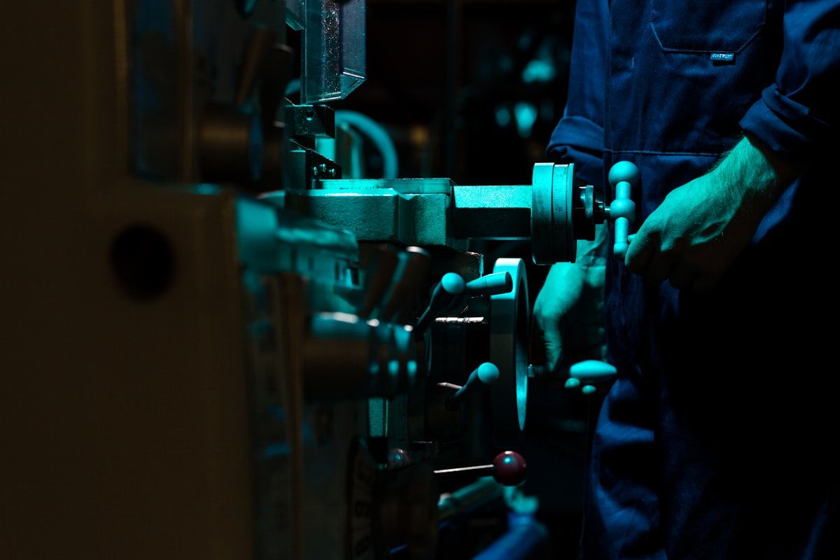 Engineer with tablet inspecting substation switchgear